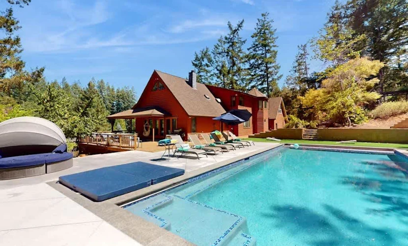Grab pool floats and chase the pups across the fenced yard — this Sebastopol fun house is built for play-all-day families and up to four dogs. Play foosball, spin shaved ice and homemade ice cream, and serve fresh popcorn from a kitchen stocked so you never have to leave. Seat up to 16 for family dinners inside or outside while one parent slips off to a quiet desk for remote work. Sleeps 8 in four bedrooms. Heated pool and spa ringed by redwoods — Marimar Estate is 0.7 miles down the road.