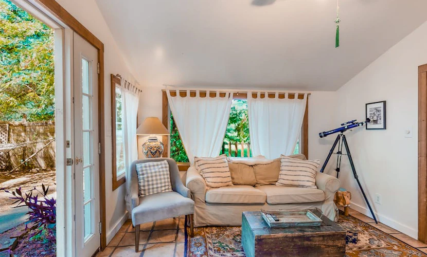 Step out the door into wine country — this dog-friendly cottage overlooks a picturesque vineyard yet sits a short walk from the Russian River, with Armstrong Redwoods 4.5 miles away. Two queen bedrooms plus a sofa bed sleep 6, and an open-air atrium connects the two buildings under a perfect view of the stars.