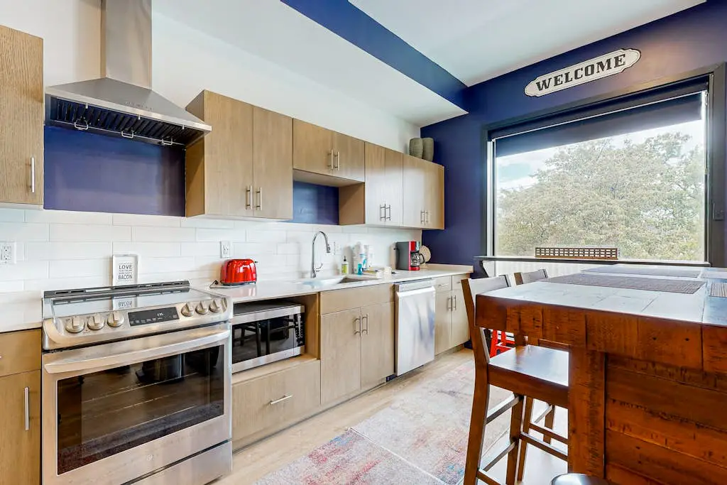 Dog-friendly treetop escape with luxe interior, seasonal pool, balcony, & WiFi