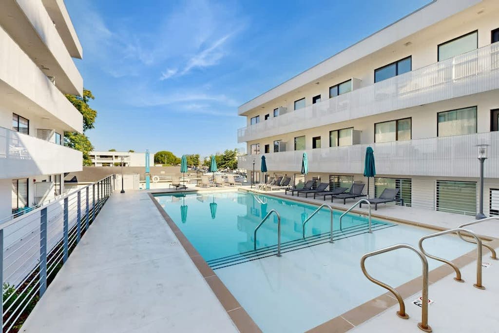 Luxe Top Floor Condo with Balcony, W/D, Seasonal Courtyard Pool, & Gym