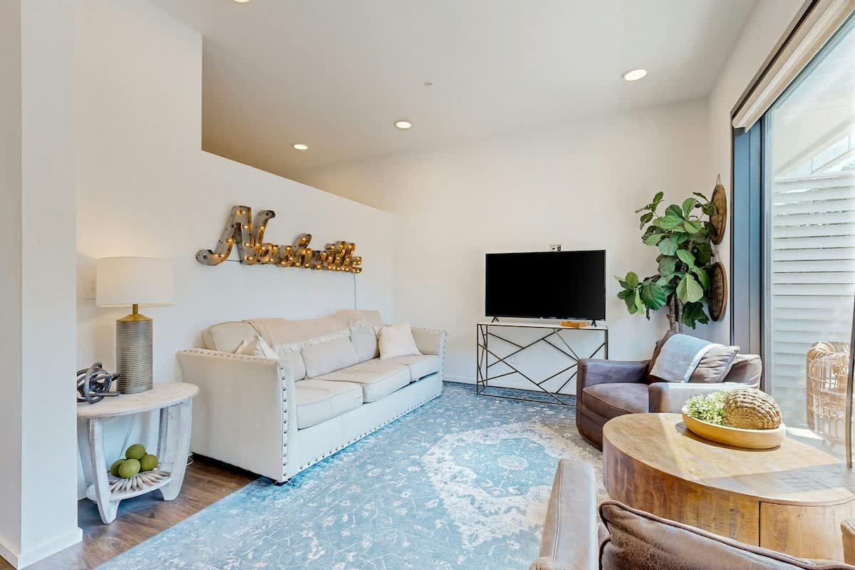 Elevated green-build condo with WiFi, balcony, central AC, W/D, and pool access