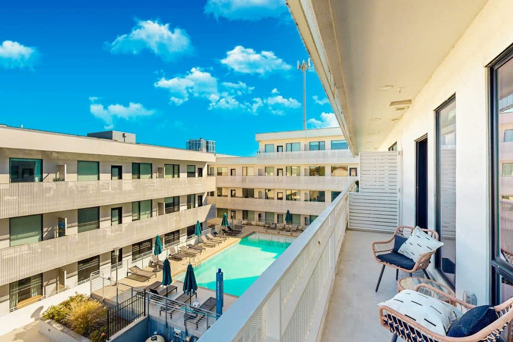 Modern end-unit condo with balcony, AC, washer/dryer & seasonal pool