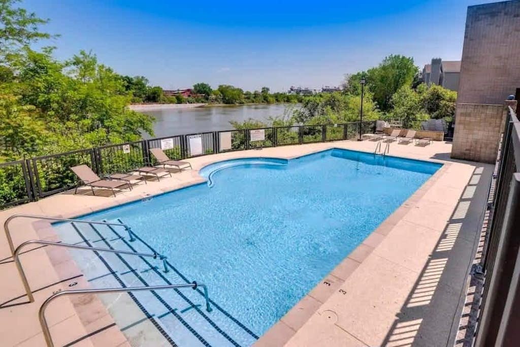 Third-floor riverfront condo with shared pool, fast WiFi, balcony, & central AC