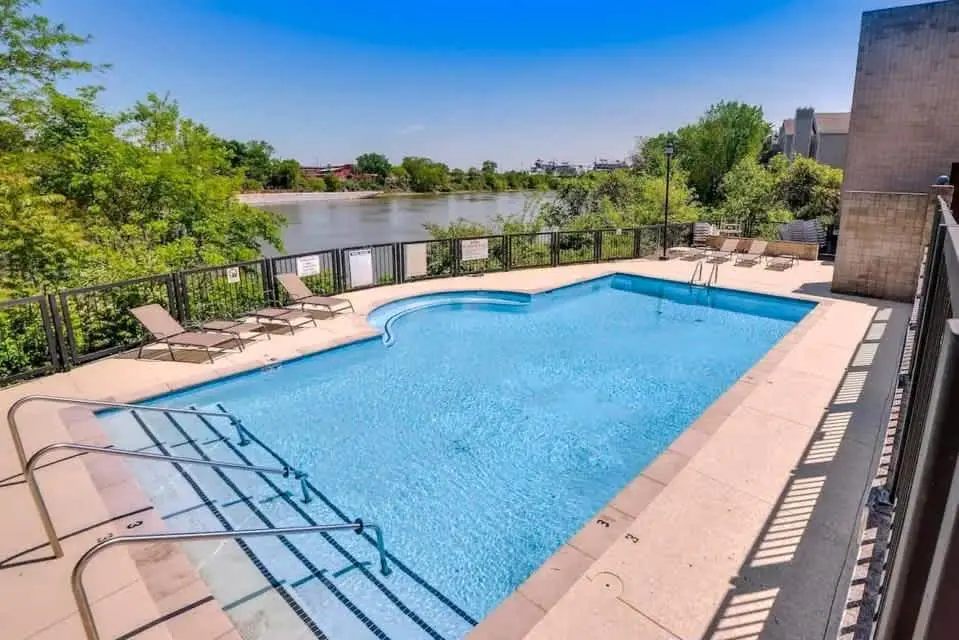 Third-floor riverfront condo with shared pool, fast WiFi, balcony, & central AC