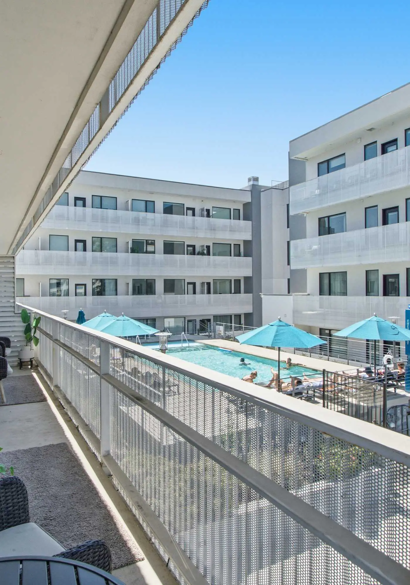 Modern condo near attractions with outdoor pool, balcony, central AC, and WiFi