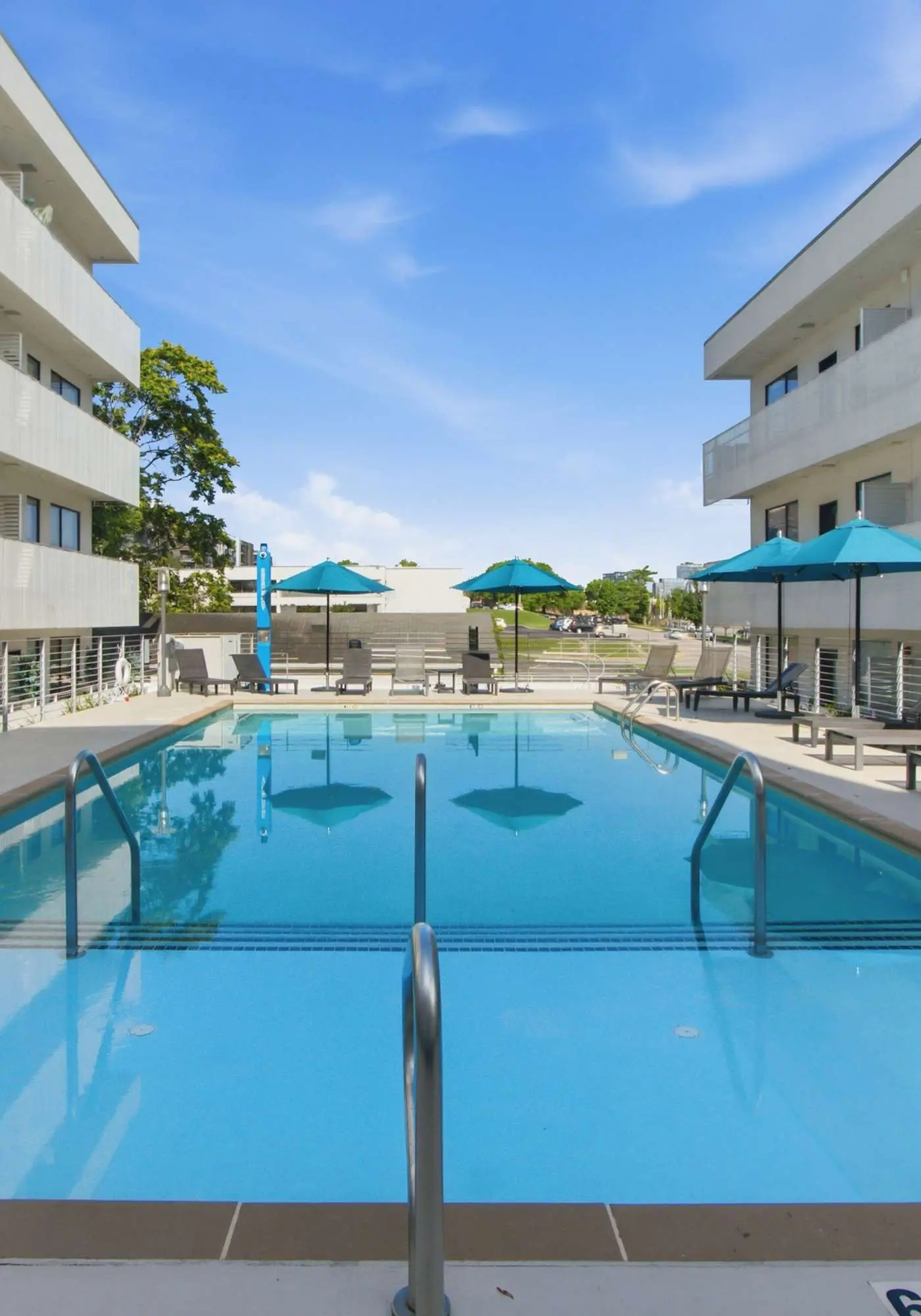 Modern condo near attractions with outdoor pool, balcony, central AC, and WiFi