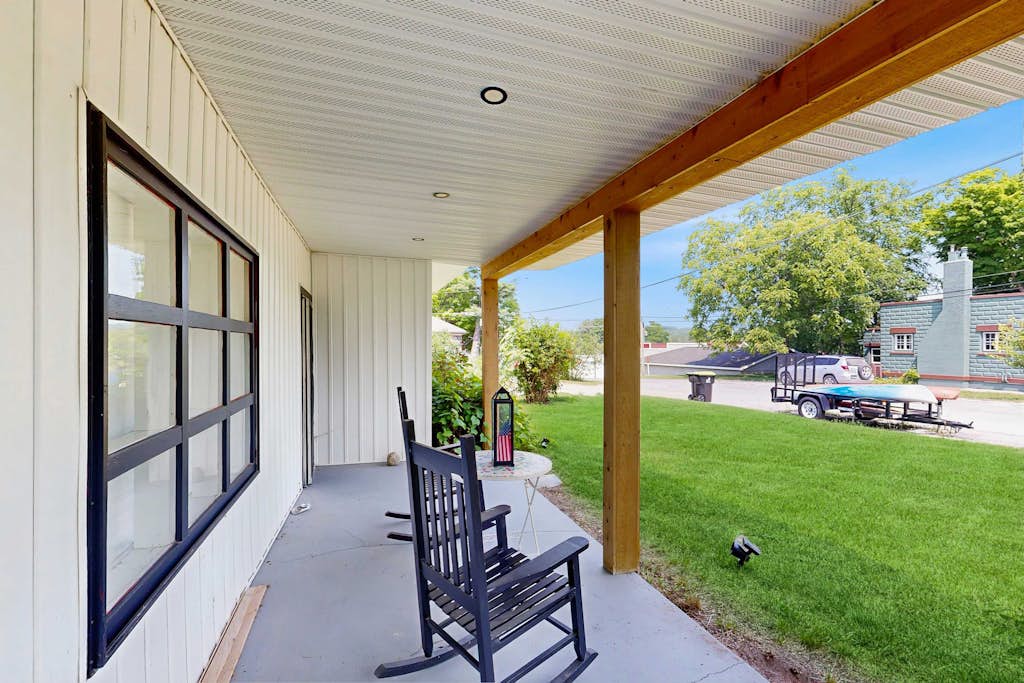 Welcome to your cozy up-north getaway in the heart of Lake Leelanau. This charming 2-bedroom, 1-bath bungalow sits just up the hill from the main street—close to everything, yet peaceful and quiet.

You can walk to four tasting rooms (three wineries and one distillery), four restaurants, two ice cream shops, two parks, a market, unique shops, and a charming coffee shop. Lake Leelanau public access is just three minutes away, and two kayaks are available for guest use so you can enjoy time on the water.

The location makes exploring easy. Downtown Leland and historic Fishtown are just 5.3 miles away. Downtown Suttons Bay is 10 minutes away, Glen Arbor is just over 20 minutes, and Traverse City is less than 30 minutes, giving you quick access to beaches, shops, and events across the peninsula.

The home comfortably sleeps couples or families with two bedrooms, each featuring a full bed, plus a full sofa bed in the living room. A fully equipped kitchen, washer and dryer, open-concept living and dining area, and a large covered front porch make it easy to settle in. Strong WiFi and two Roku TVs allow you to stream your favorite shows after a day of adventure. Mini-split systems provide efficient heating and partial air conditioning, and multiple ceiling fans and screened windows bring in the refreshing northern Michigan breeze.

For guests who like to stay active, a Peloton bike is also available for your use during your stay

Traveling with kids? They’ll enjoy two kid-sized tables—one near the kitchen and one in the foyer for coloring—along with puzzles and children’s books provided during your stay.

Whether you're kayaking at sunrise, wine tasting in the afternoon, riding the Peloton before heading out, or enjoying ice cream after dinner, this bungalow is the perfect home base for your Leelanau Peninsula escape.

Things to know: 
There are exterior cameras at this home. 
This property is managed by VueStay Vacations.  Michigan Real Estate license #6505433797.