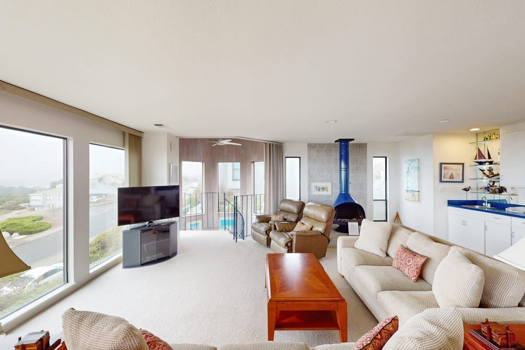 Floor-to-ceiling windows frame the Pacific as you sink into plush seating by the gas fireplace. Challenge friends to pool or ping-pong in your private game room, then grill fresh seafood on the ocean-view balcony. This 3-bedroom coastal retreat sleeps 8 with two California king suites. Just 0.2 miles from Birdwalk Coastal Access Trail and 0.5 miles from Sonoma Coast Vineyards. Watch gray whales migrate past from December through May — Bodega Head's famous viewing spot is minutes away.