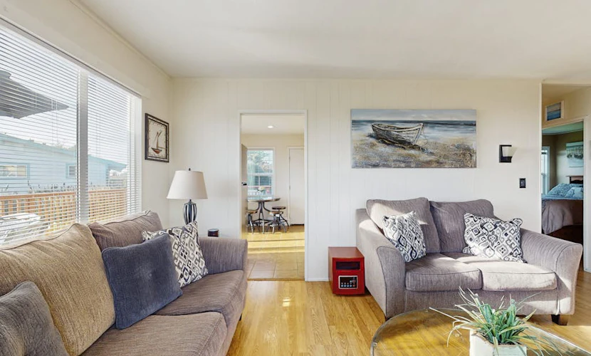 Soak in the private hot tub as Pacific fog burns off the bluff, then walk five minutes to Schoolhouse Beach or Carmet Beach to comb for sea glass and driftwood. This nautical-themed Carmet cottage sleeps 5 across two queen bedrooms and a sofa bed, with a wrap-around deck, gas grill, and ocean views from the living room. Dogs welcome.