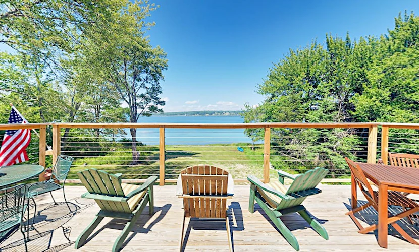 Renovated waterfront cottage with expansive deck, multiple fireplaces, & grill