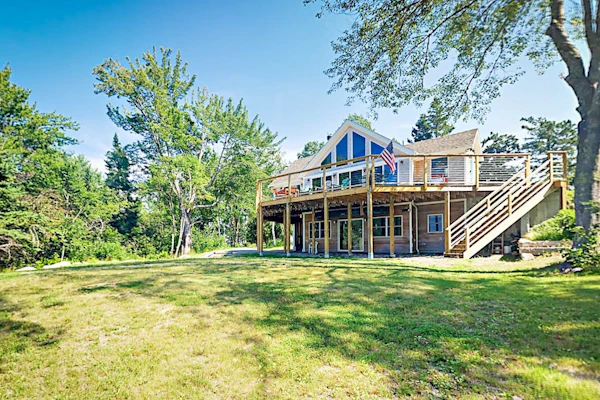 Renovated waterfront cottage with expansive deck, multiple fireplaces, & grill