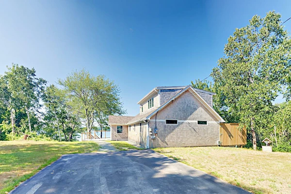 Renovated waterfront cottage with expansive deck, multiple fireplaces, & grill