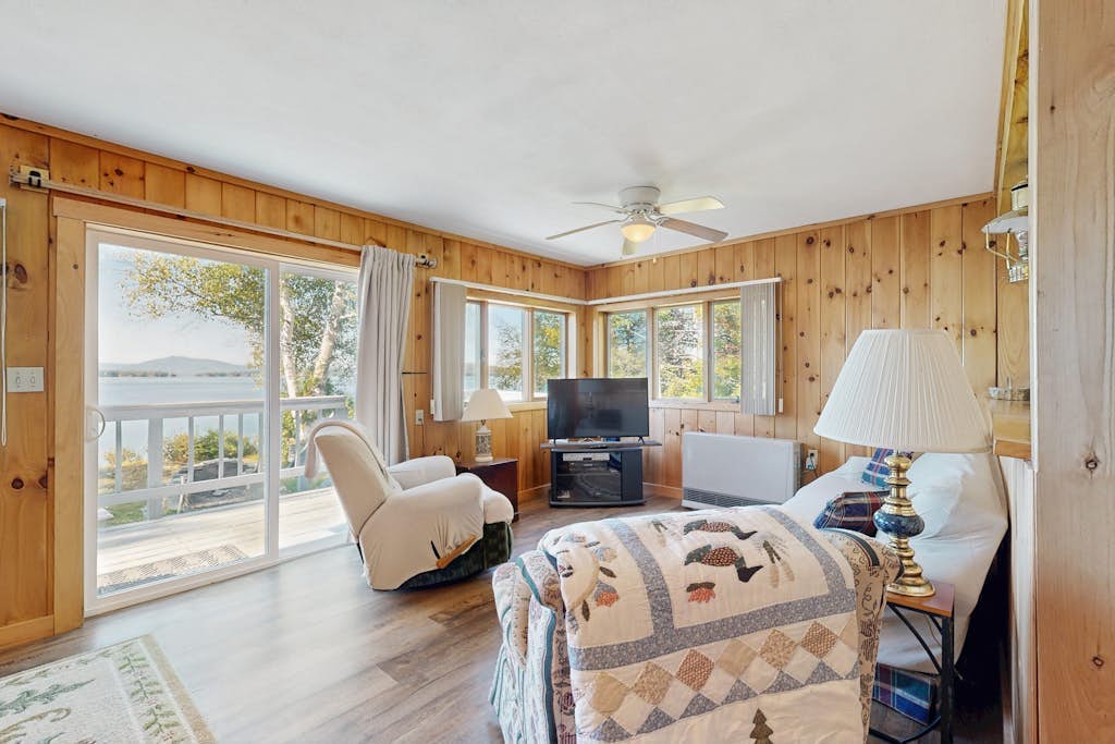 Lakefront home with private dock, mooring, pebble beach, grill, & firepit