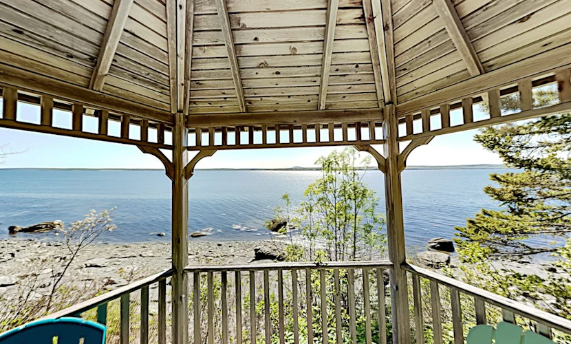Charming home with stunning bay views, sunroom, gazebo, deck, & grill