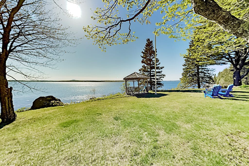 Charming home with stunning bay views, sunroom, gazebo, deck, & grill