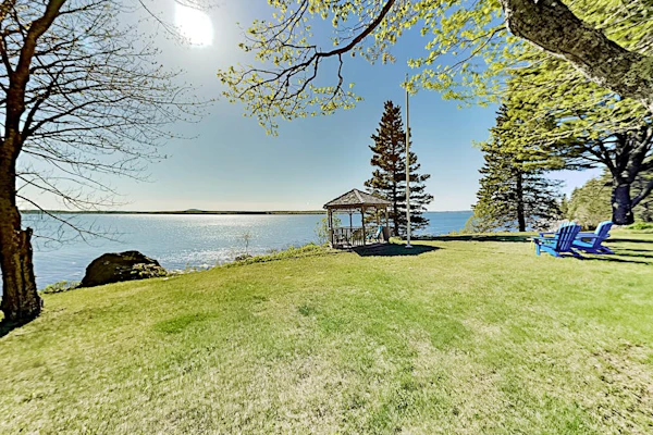 Charming home with stunning bay views, sunroom, gazebo, deck, & grill