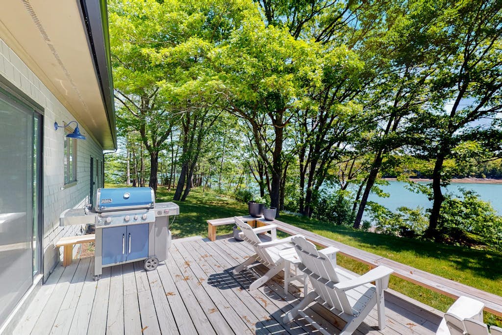Water-view retreat with beach access, deck, grill, EV charger & lawn games