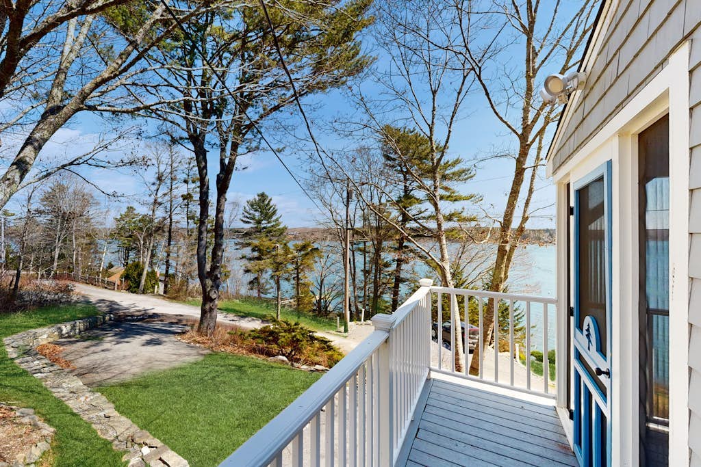 Dog-friendly river-view home with wood stove, deck, patio, dock, beach, grill