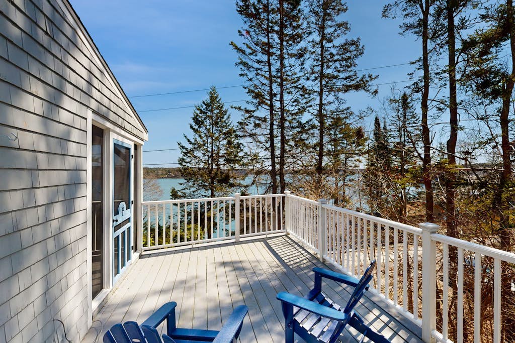 Dog-friendly river-view home with wood stove, deck, patio, dock, beach, grill