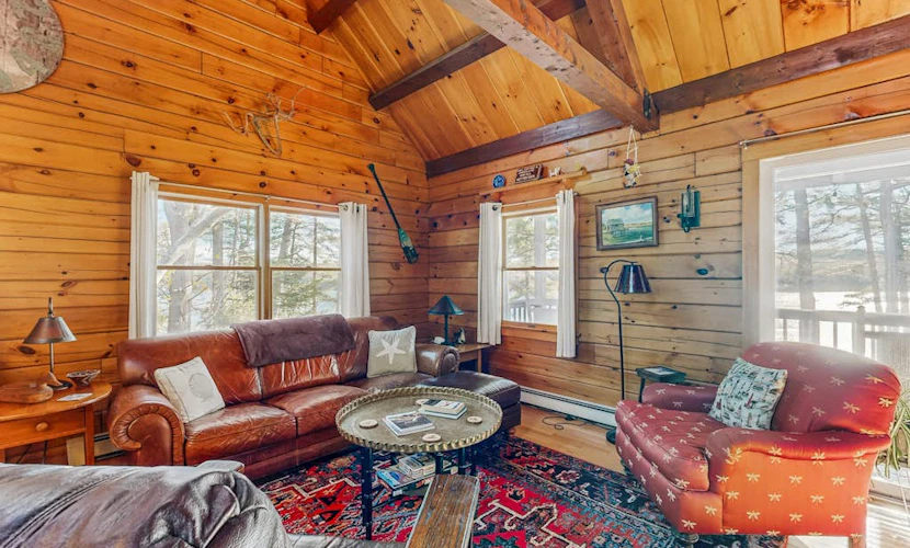 Charming riverfront home with cozy interiors, dock, and scenic deck views