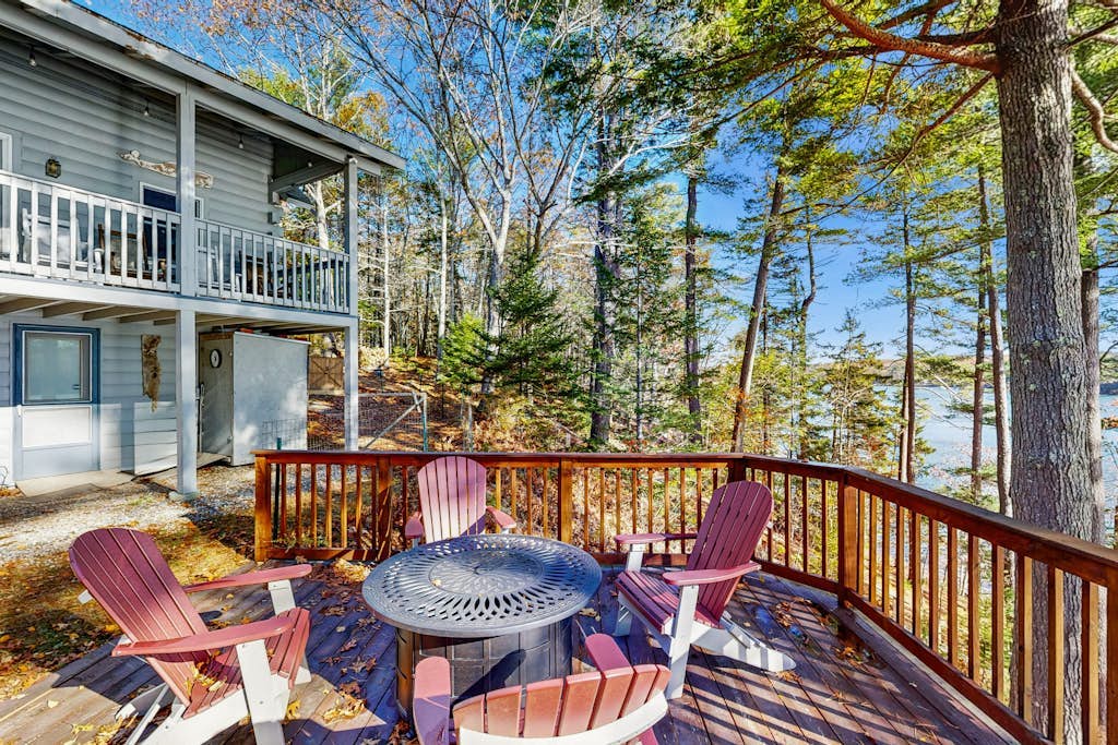 Charming riverfront home with cozy interiors, dock, and scenic deck views