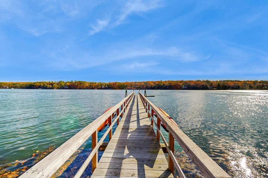 Charming riverfront home with cozy interiors, dock, and scenic deck views