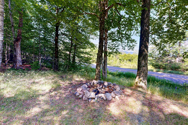 Scenic retreat with a spacious deck, gas fireplace, and Moosehead Lake views