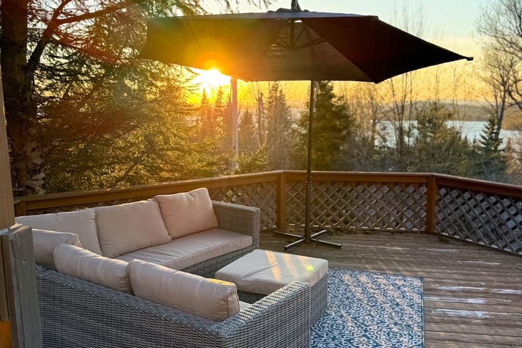 Scenic retreat with a spacious deck, gas fireplace, and Moosehead Lake views