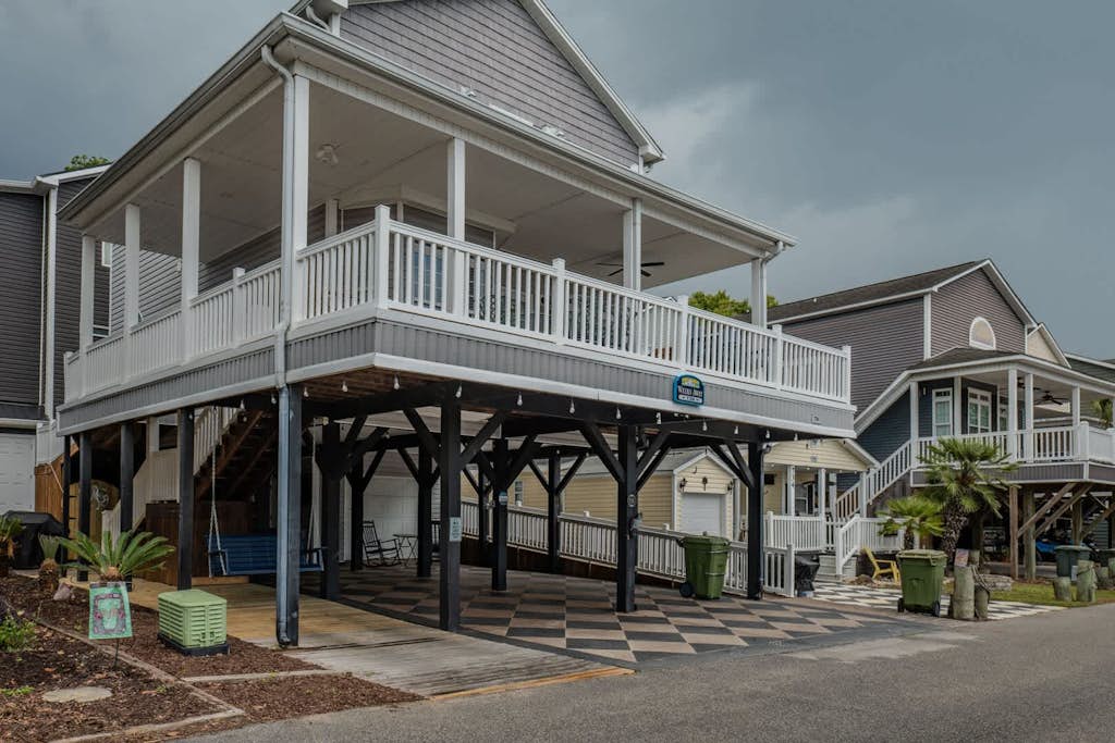Step into this stunning 5 bedroom, 3 and a half bath beach retreat located in the highly sought after Ocean Lakes community, where comfort, space, and thoughtful updates come together to create the perfect coastal getaway. Designed to accommodate up to 10 guests with ease, this spacious home offers a warm and inviting atmosphere with sleeping arrangements that include 3 queen-sized beds and 2 full sized beds, giving everyone their own comfortable place to unwind after a day at the beach.