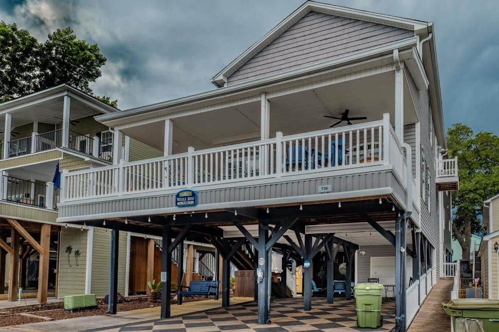 Step into this stunning 5 bedroom, 3 and a half bath beach retreat located in the highly sought after Ocean Lakes community, where comfort, space, and thoughtful updates come together to create the perfect coastal getaway. Designed to accommodate up to 10 guests with ease, this spacious home offers a warm and inviting atmosphere with sleeping arrangements that include 3 queen-sized beds and 2 full sized beds, giving everyone their own comfortable place to unwind after a day at the beach.