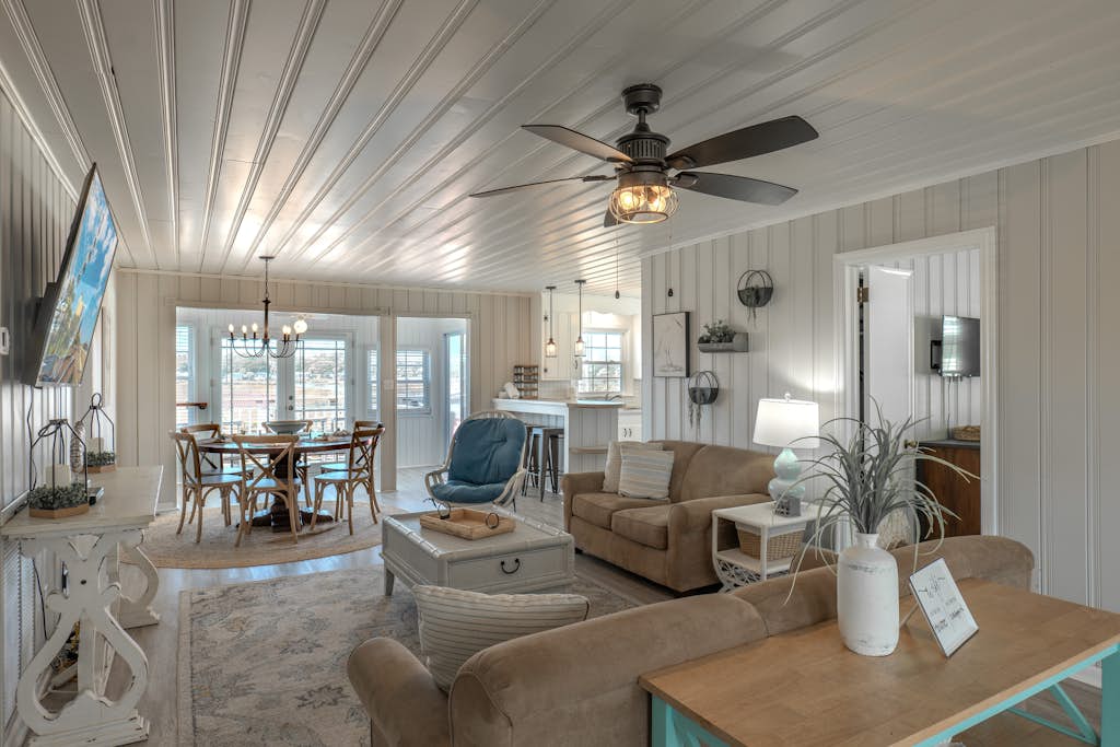 Welcome to Mystic C&rsquo;s, a stylish five bedroom inlet side escape designed for unforgettable group getaways. With tall balconies overlooking the water, arcade games, kayaks, and a brand new in ground pool currently in the works, this spacious home offers the perfect setting for your next beach vacation. Thoughtfully furnished with two king beds, three queen beds, two twin beds, one twin with a twin trundle, and a queen sleeper sofa, the home comfortably accommodates up to 16 guests. It's important to note that the photos of the pool are purely renderings. The pool is expected to be complete by May 1, 2026.