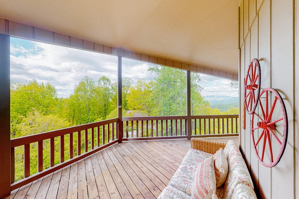 View-worthy home lined by trees with a fireplace, wrap-around deck, grill, & W/D