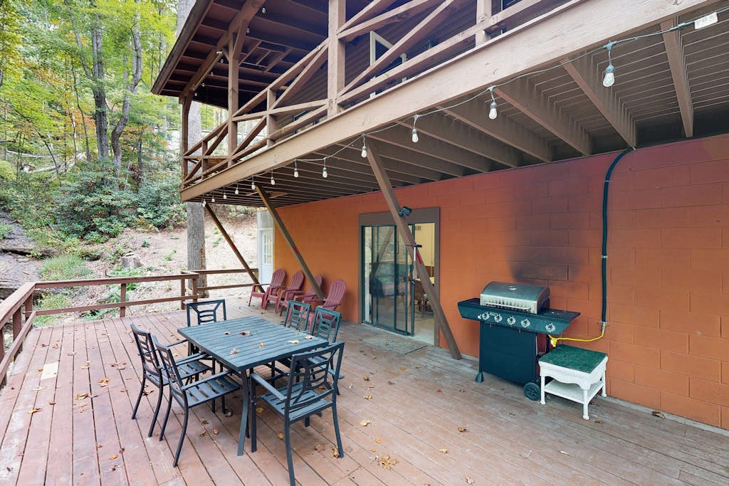 Mountain home nestled in the forest with a stream, deck, firepit, & game room