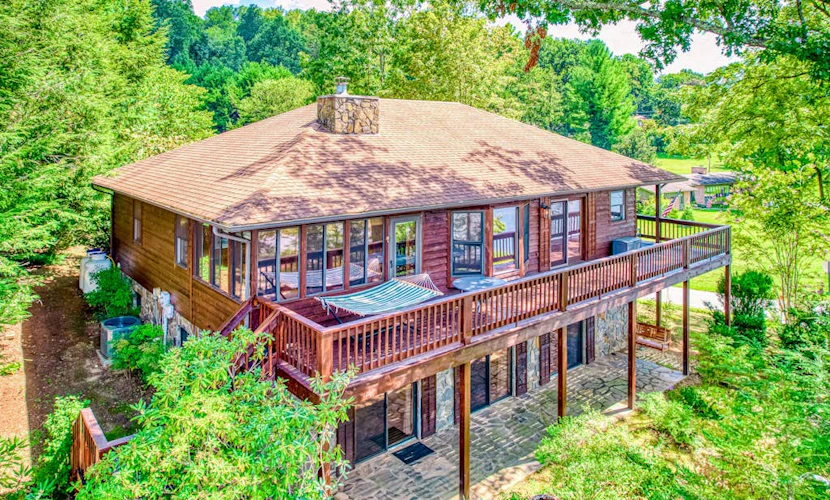 Lakeside retreat with water views, pool, wraparound deck, patio & game room