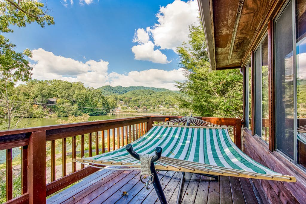 Lakeside retreat with water views, pool, wraparound deck, patio & game room
