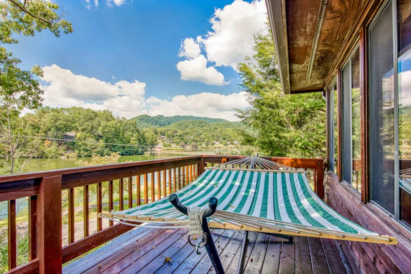 Lakeside retreat with water views, pool, wraparound deck, patio & game room