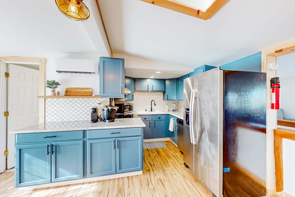 Tree-lined lake view abode with large deck, modern interior, board games, & W/D