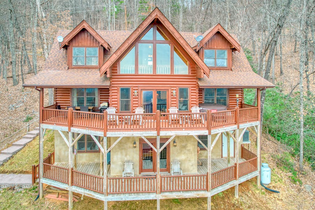 Rustic mountain-view home with deck, fire pit, hot tub, fireplace, & game room