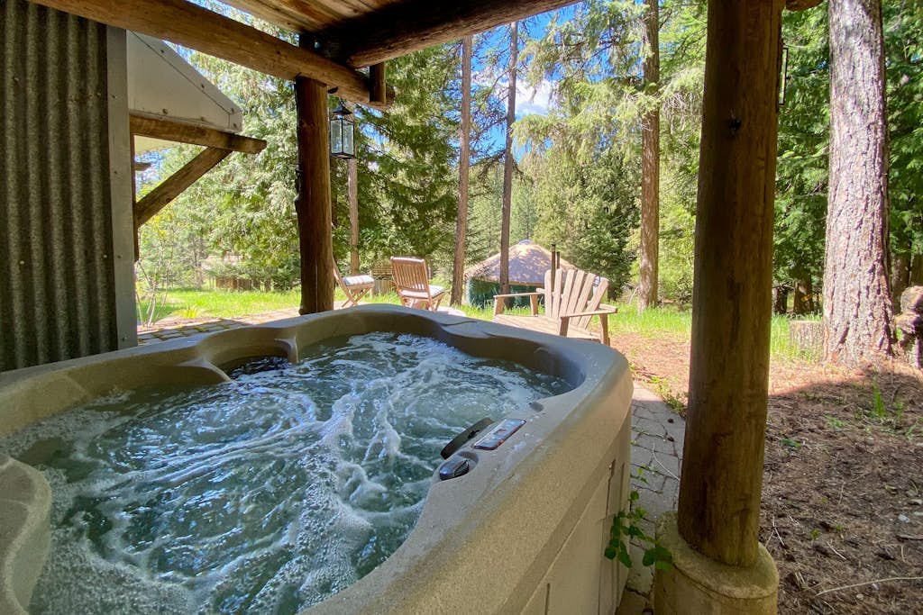Rustic woodland home with hot tub, patios & fireplaces - near lake access