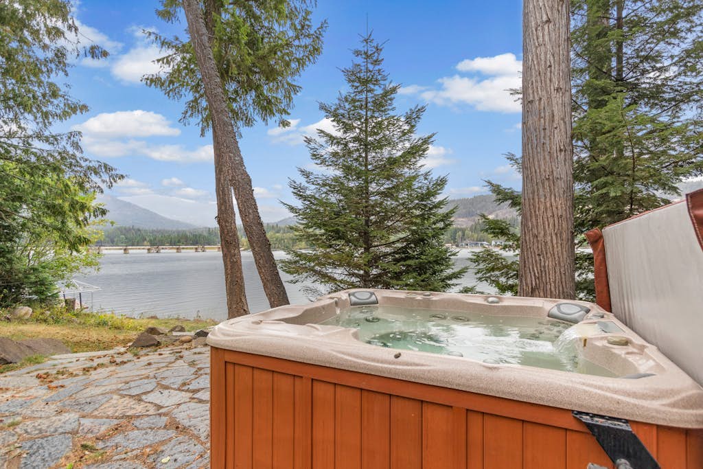 Riverfront home with mountain view, hot tub, deck, WiFi, W/D, & fireplace