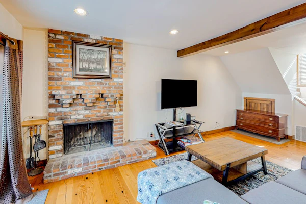 Inviting riverfront home with balcony, fireplace, skiing, W/D & dog-friendly
