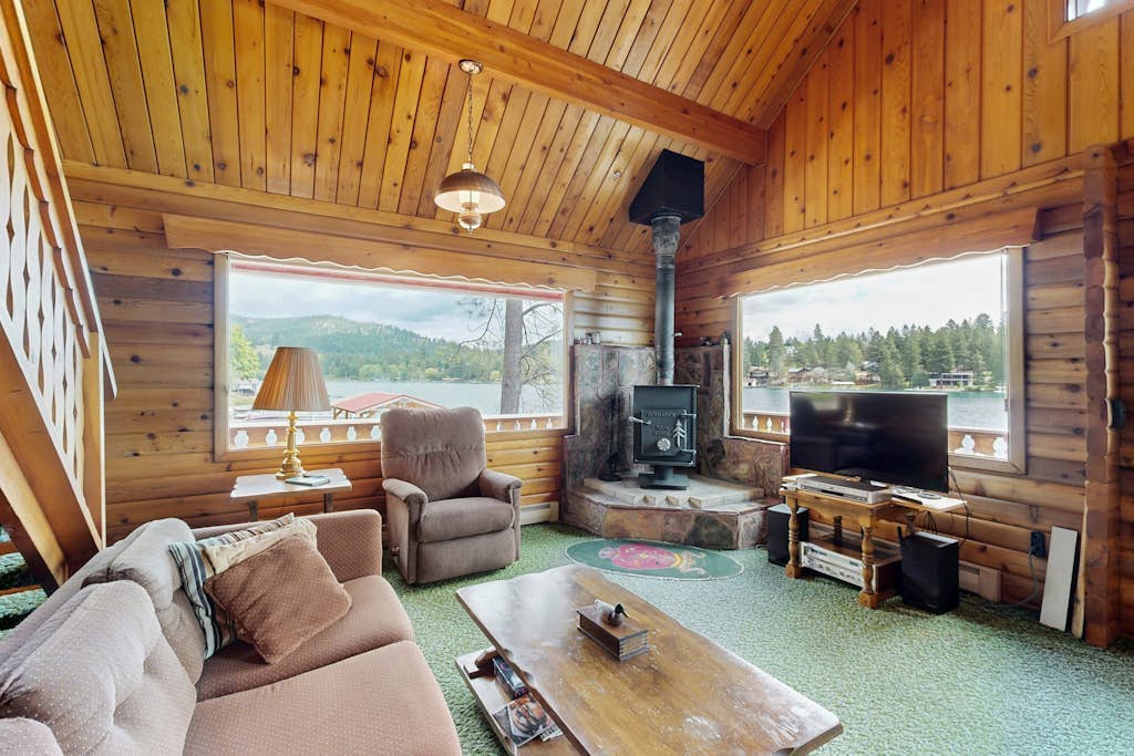 Cozy lakefront log cabin with lake views, vintage decor, & dock