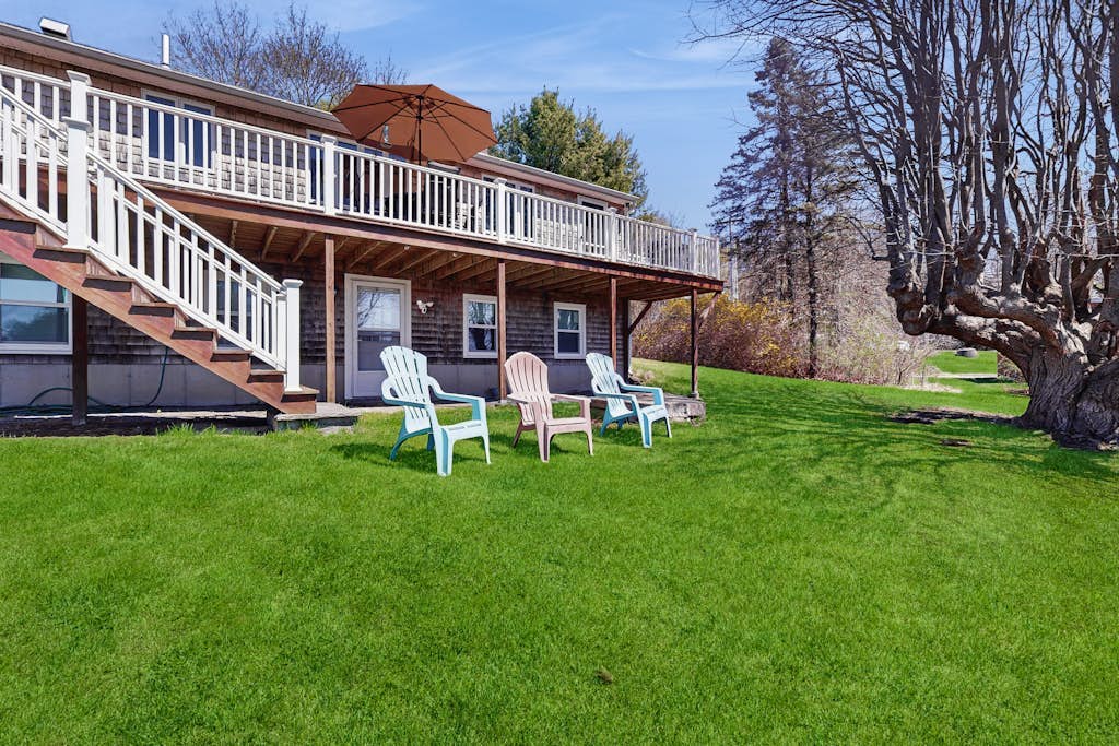 Tranquil waterfront home with stunning views, a spacious deck, and a BBQ grill