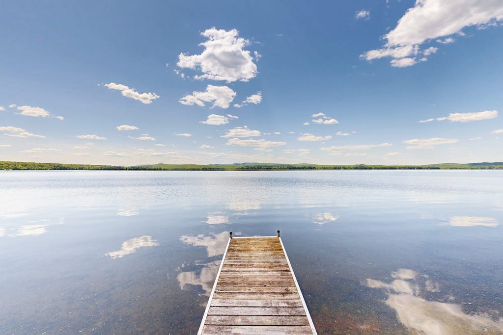 Lakefront dog friendly cottage w/ a dock & beautiful sunset views