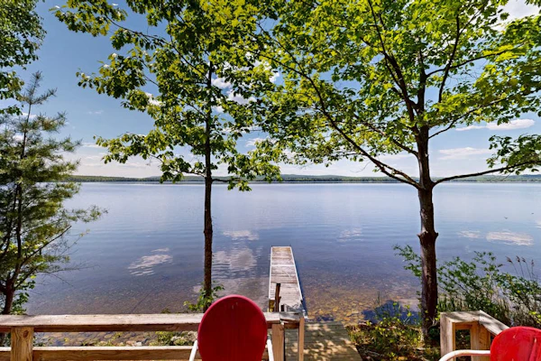 Lakefront dog friendly cottage w/ a dock & beautiful sunset views