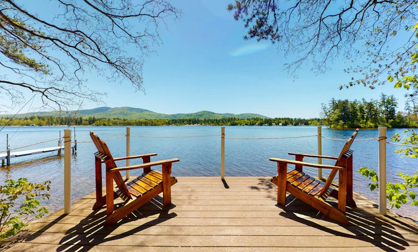 Homey lakeside property w/ one house, two cottages, mtn. views, & private beach