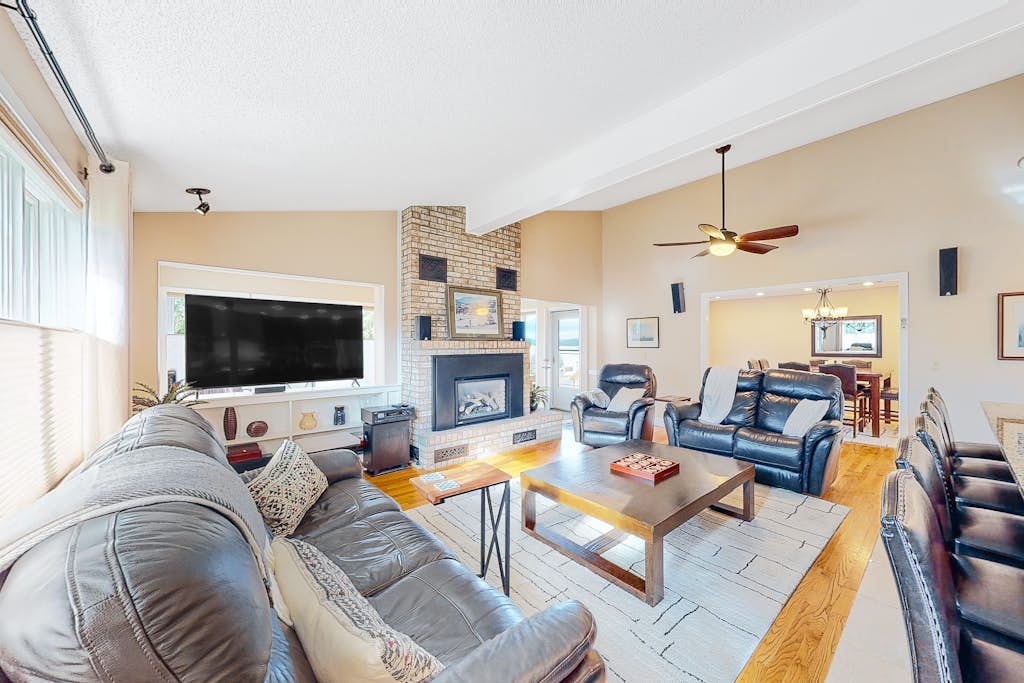 Lakefront home with pool, beach access, central AC, washer/dryer, & fireplace