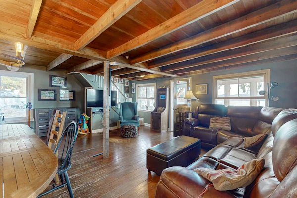 Dog-friendly cabin on the water with a sunroom, firepit, & full kitchen