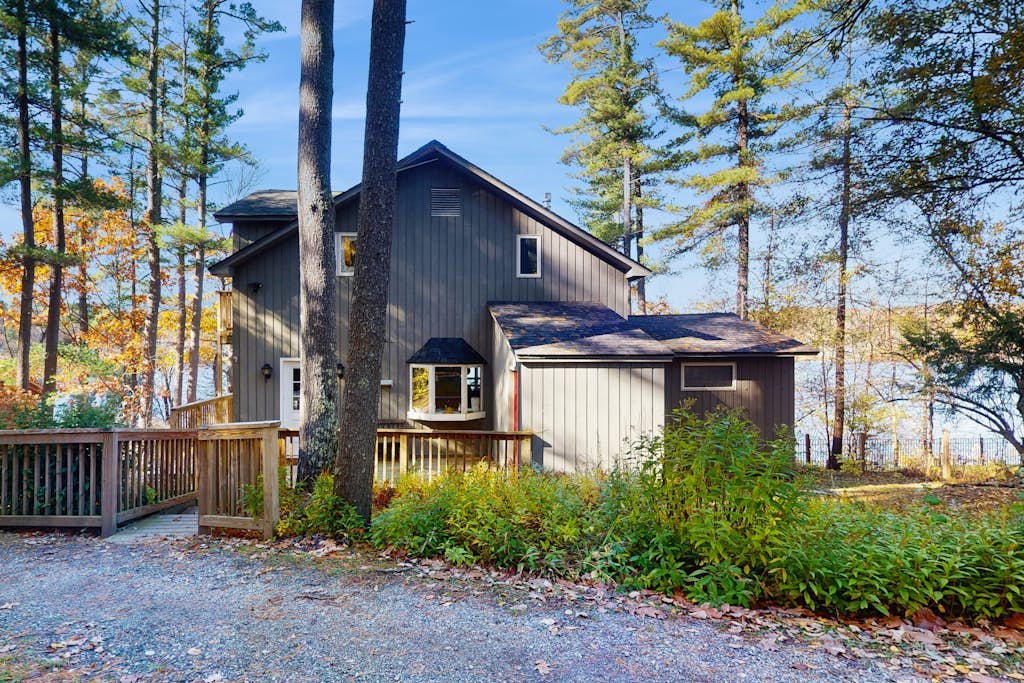Lakefront home near ski resorts with water view, dock, deck, fireplaces, & W/D