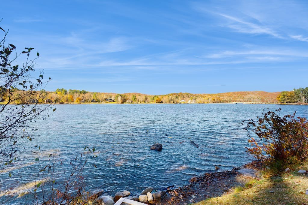 Lakefront home near ski resorts with water view, dock, deck, fireplaces, & W/D